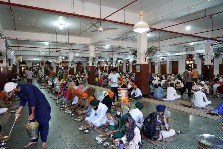 Langar at Golden Temple, Amritsar — people eating together irrespective of caste or class.